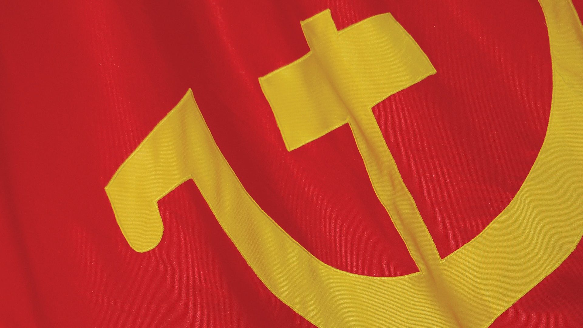 Members of the Portuguese Communist Party Youth carry flags and